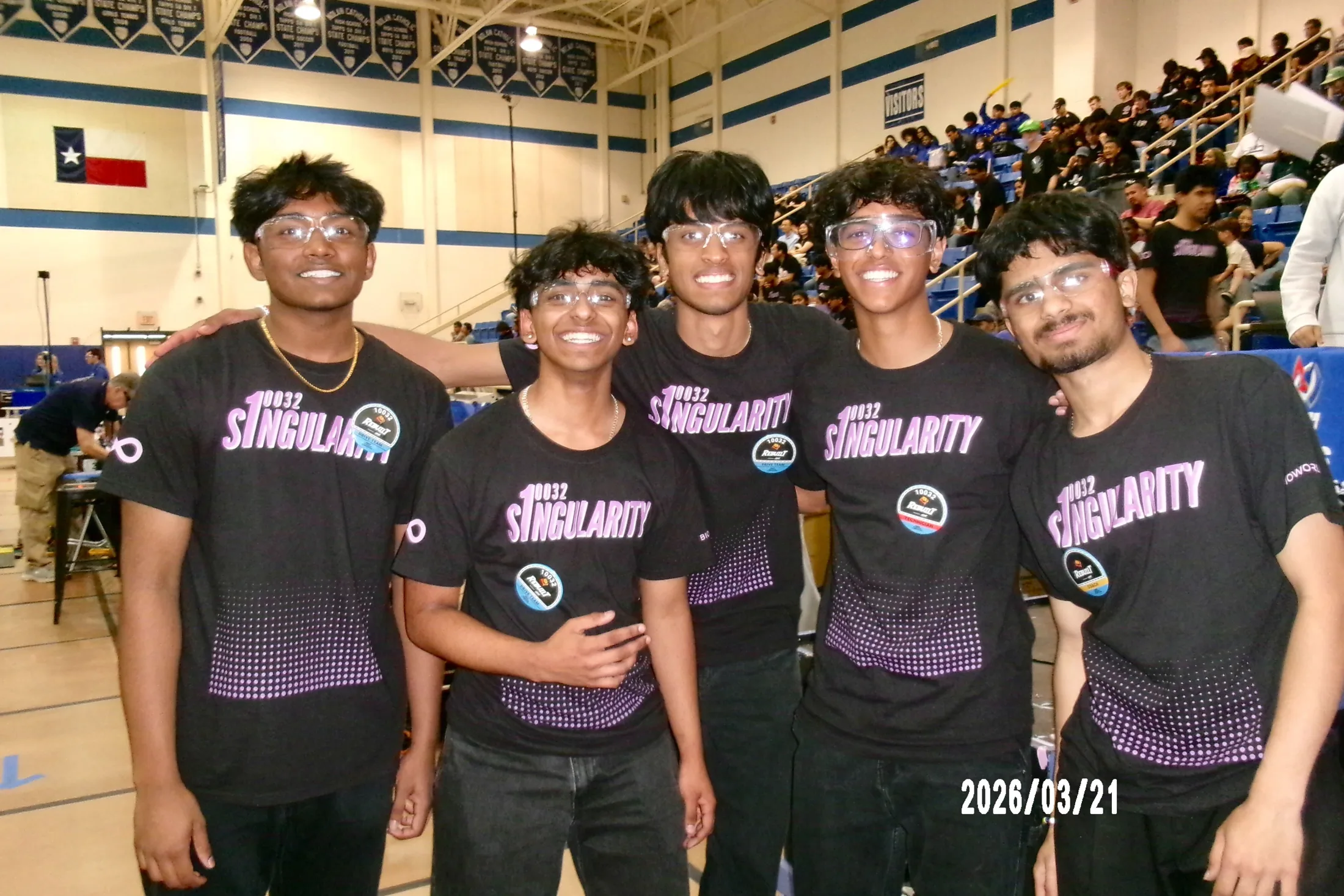 Members in team shirts in the stands