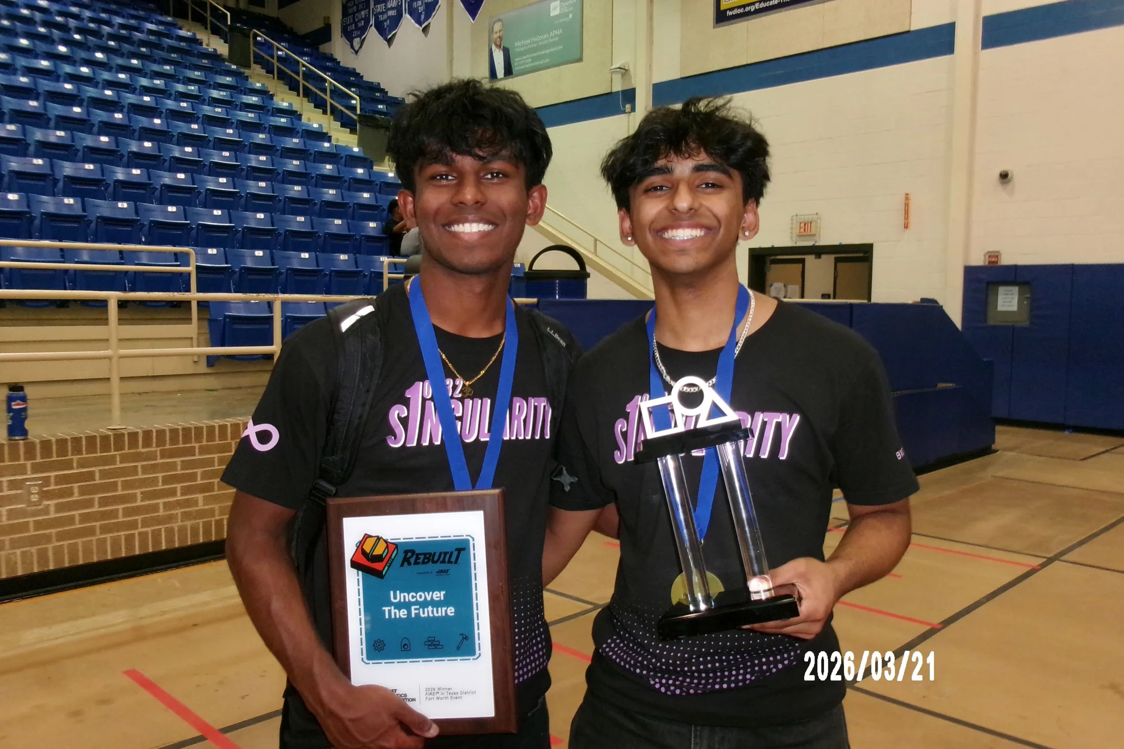 Two members with the winner plaque and trophy