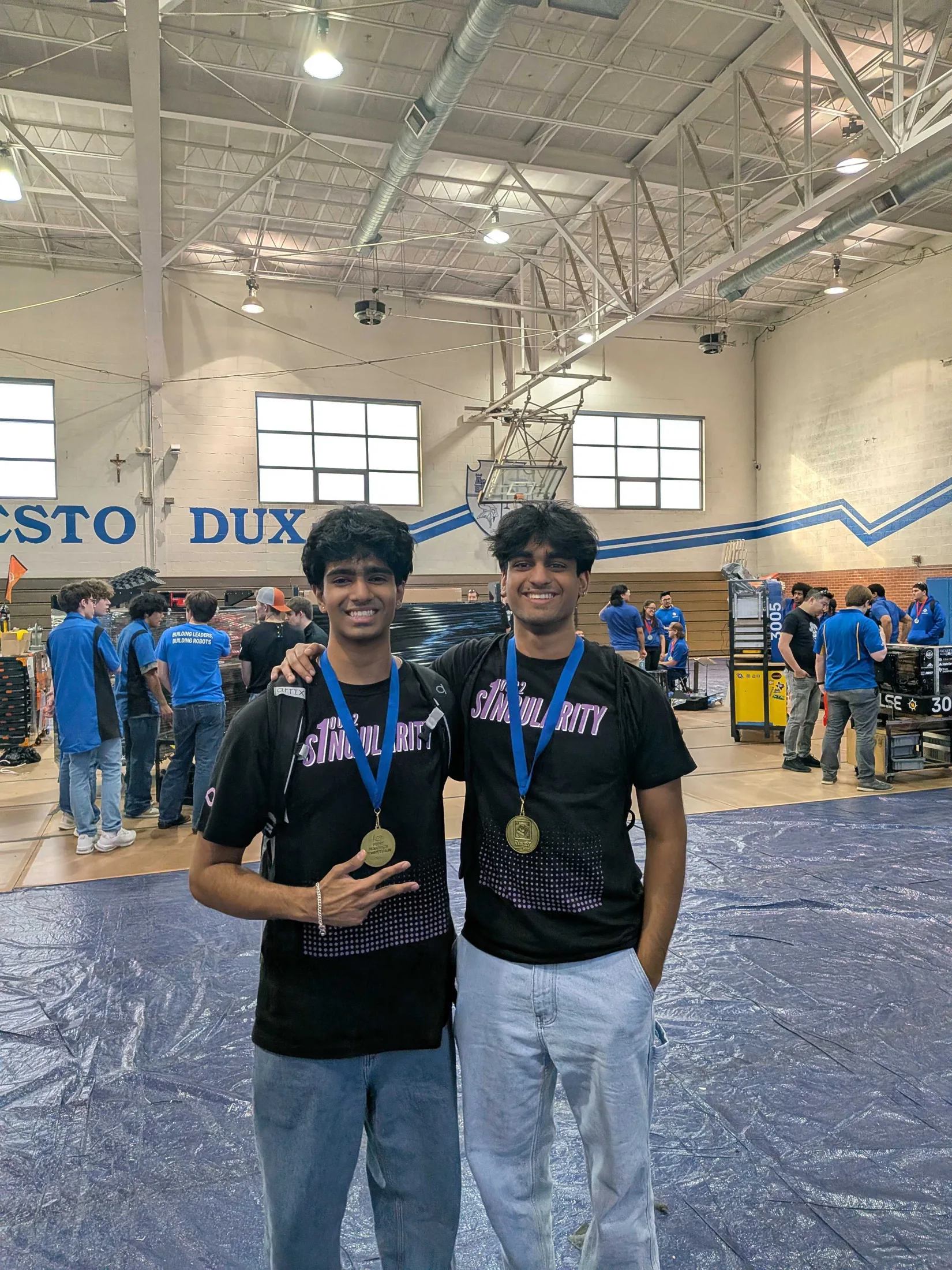 Two members with medals in the gym