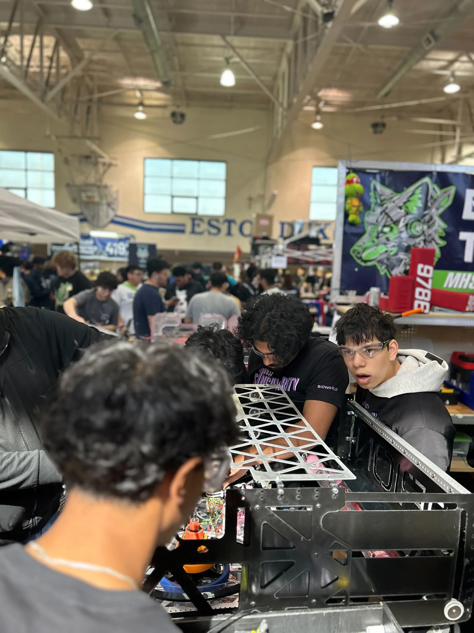 Students working on the robot in the pit