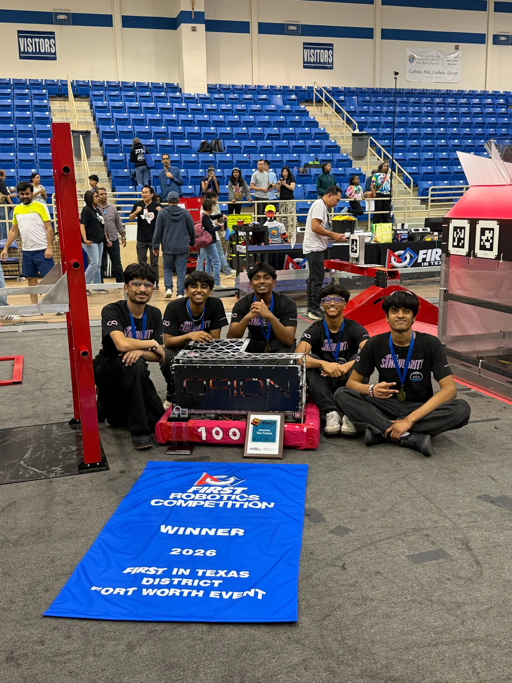 The team seated with the winner banner and ORION