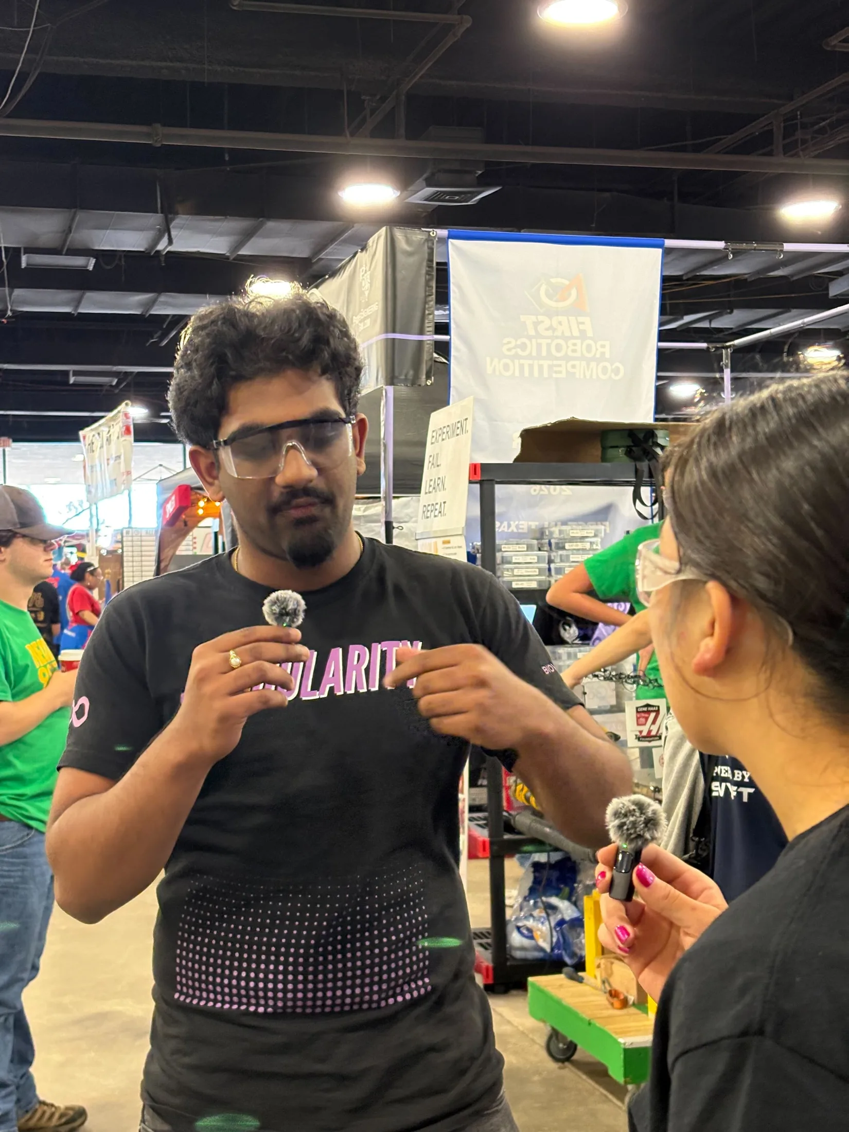 A student talking with a visitor at an outreach table