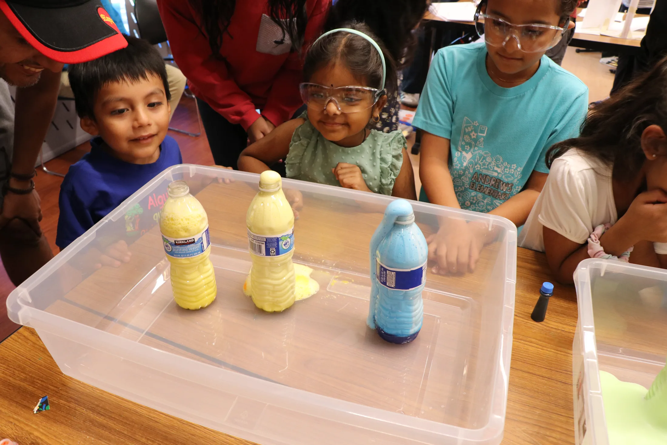 Young kids doing a water and bottle STEM activity
