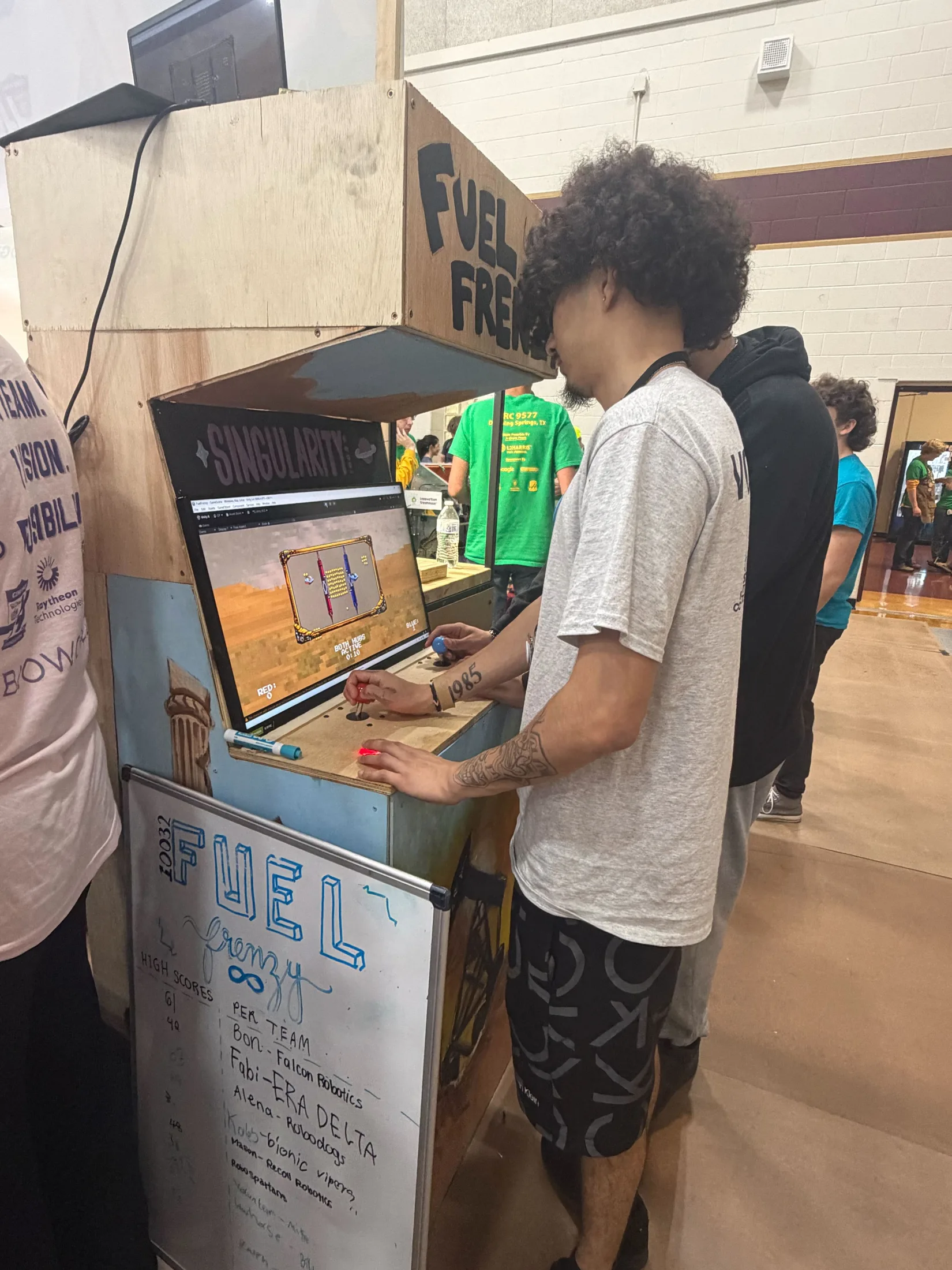 Students playing the Fuel Frenzy cabinet
