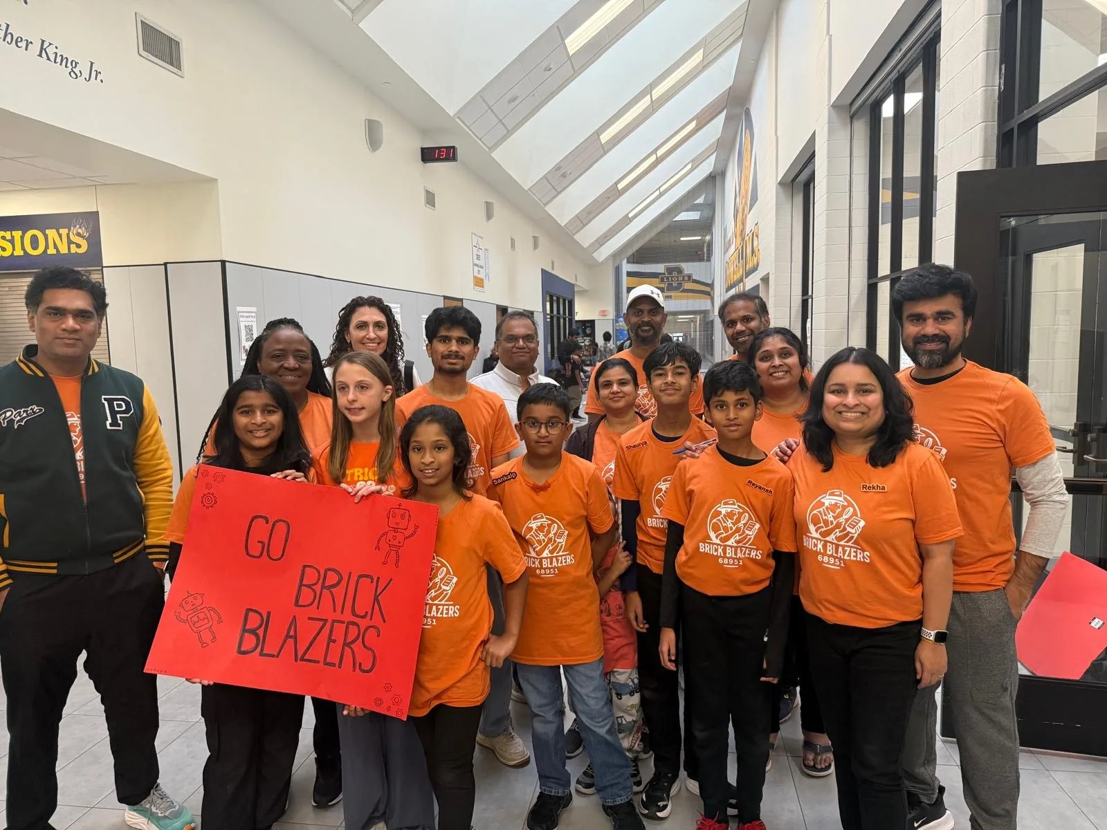 Outreach group with a Go Brick Blazers sign