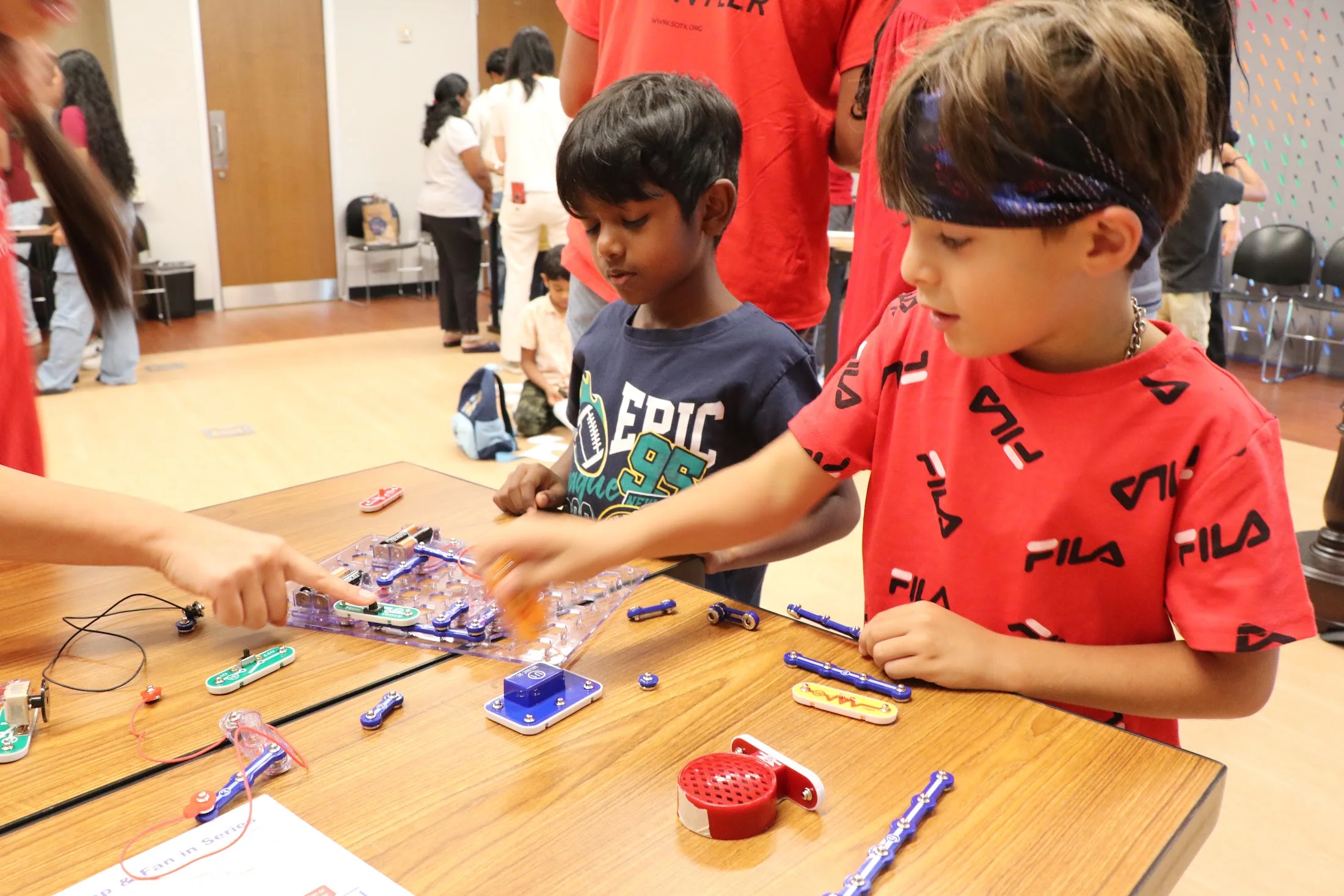 A boy wiring his snap circuit