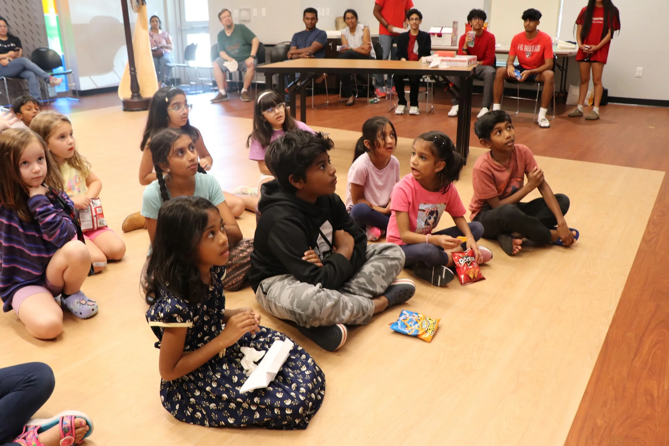 Kids seated for the workshop talk