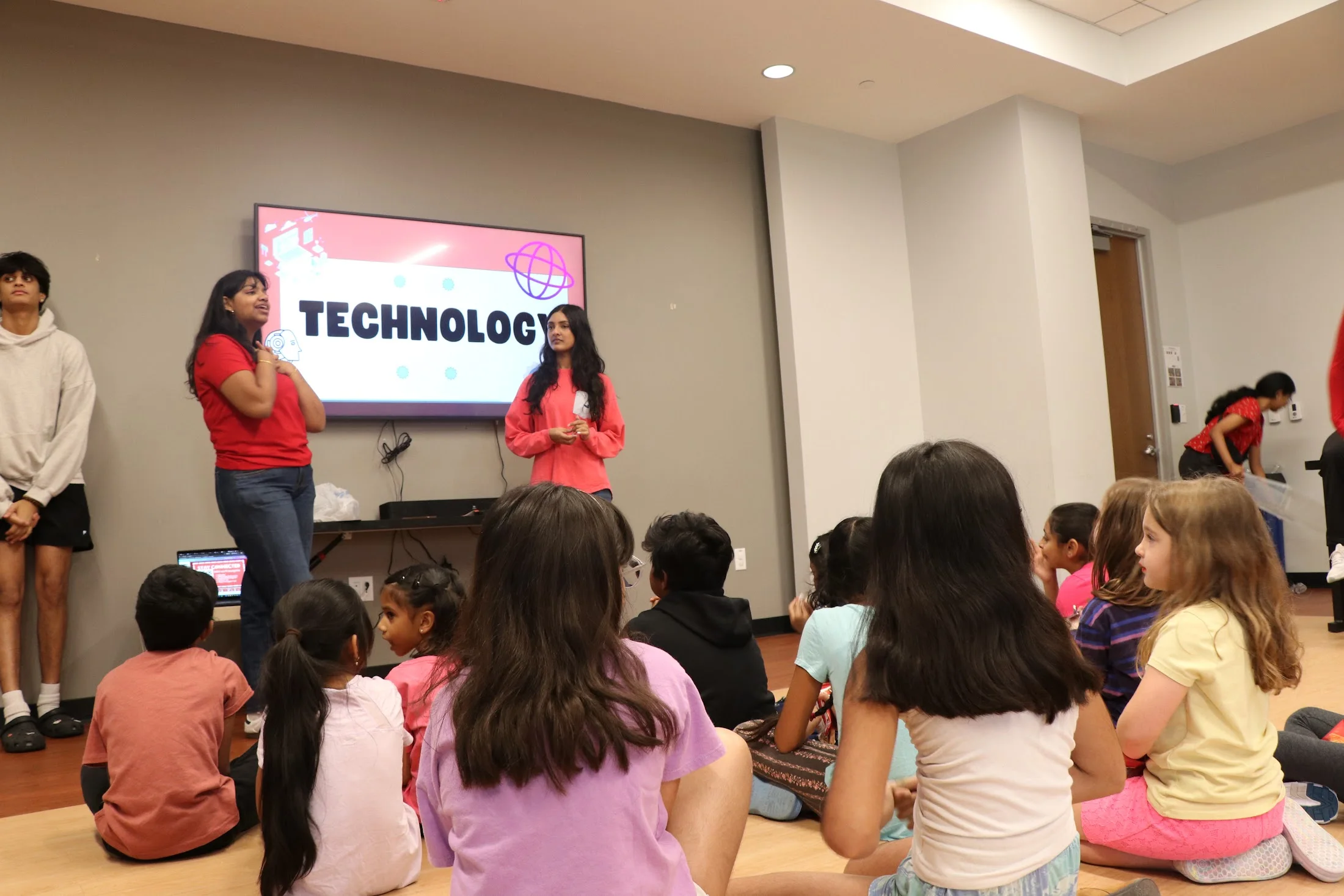 The technology segment, kids seated in front of the screen